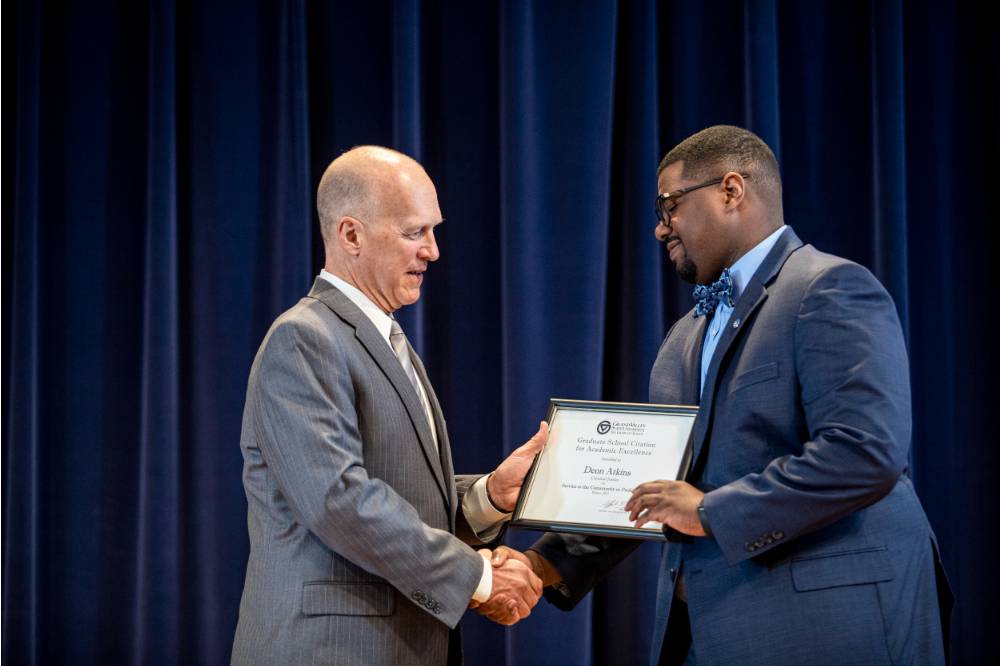 Dr. Potteiger (left) giving Deon Atkins (right) his award.